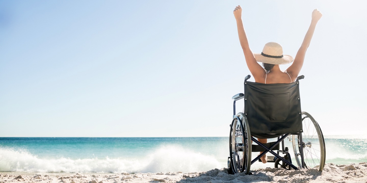 Woman on a wheelchair at the beach